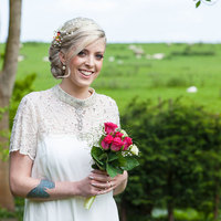 Kent Hair & Makeup Artist | Bride smiling holding her bouquet